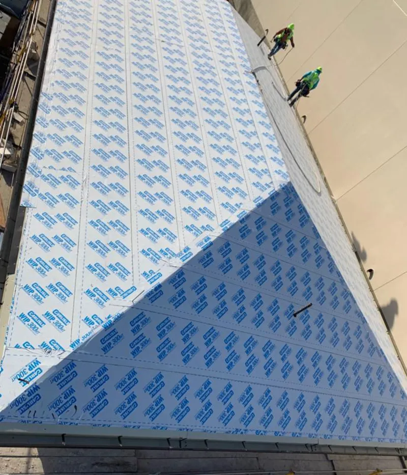 Professional roofers installing underlayment on a metal roof in Baker City